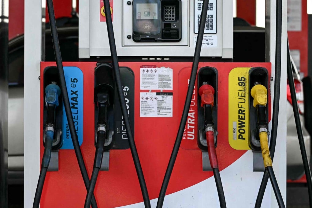 Fuel pump nozzles are seen at a petrol station in Kuching, Sarawak, Malaysia. Photo: AFP