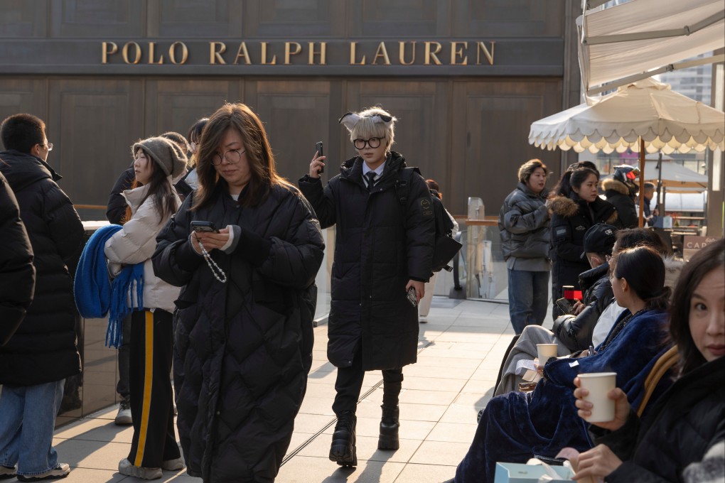 Shoppers walk past the Ralph Lauren flagship store in Beijing. Photo: AP