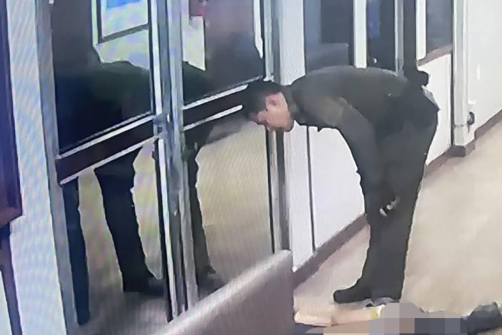 A Thai officer interacts with a woman who was brought to a police station instead of a hospital following a motorcycle crash in Bangkok. Photo: Facebook / anuwatf.ch7