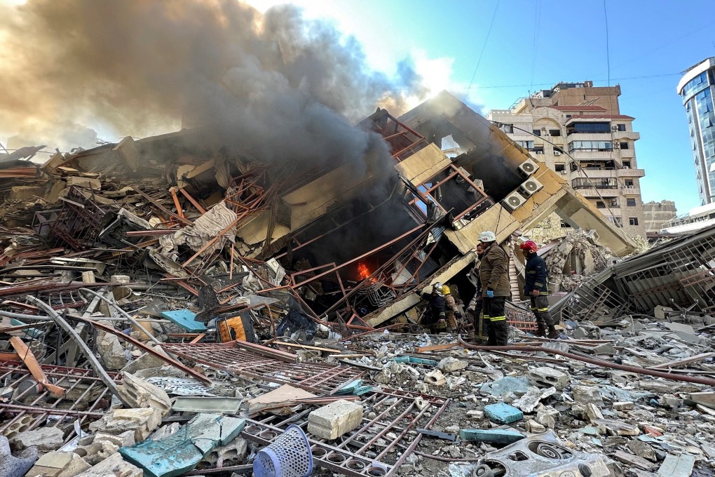 Members of the Lebanese Civil Defence inspect a damaged building after an Israeli strike on Beirut’s southern suburbs. Photo: Reuters