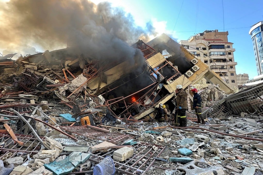 Members of the Lebanese Civil Defence inspect a damaged building after an Israeli strike on Beirut’s southern suburbs. Photo: Reuters