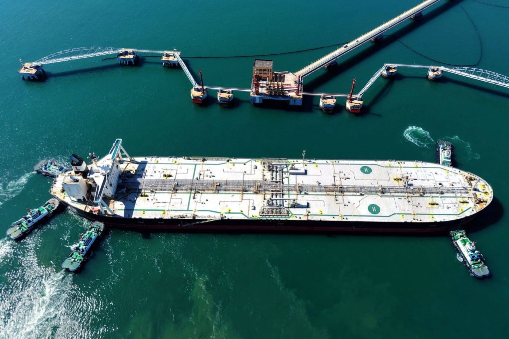 A crude oil tanker is guided to a berth at a terminal in China’s Shandong province on Saturday. Photo: AFP