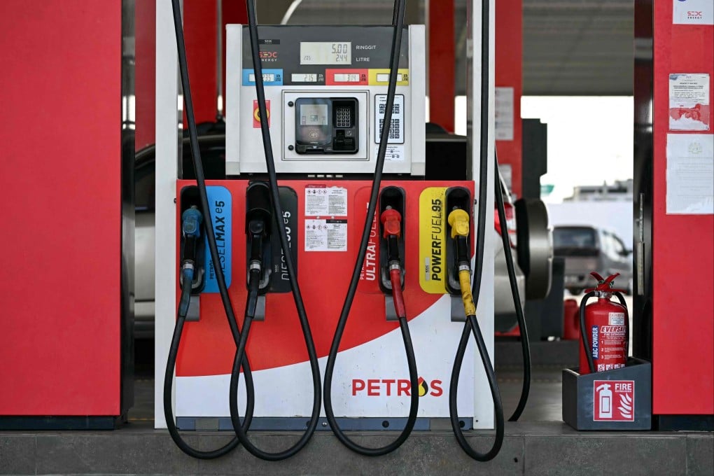 Fuel pump nozzles are pictured at a petrol station in Kuching, Sarawak. Malaysia will keep subsidised petrol prices unchanged despite the global increase in crude oil costs. Photo: AFP