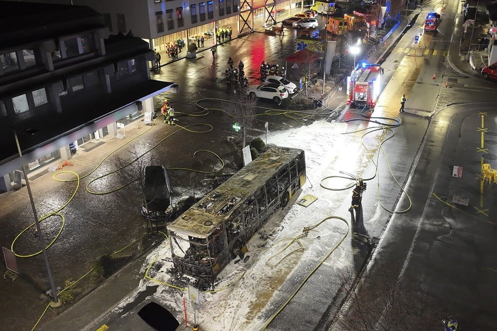 Fire investigators examine the charred shell of a bus after it caught fire in Kerzers, Switzerland, on Tuesday. Photo: Kontonspolizei Freiburg via EPA