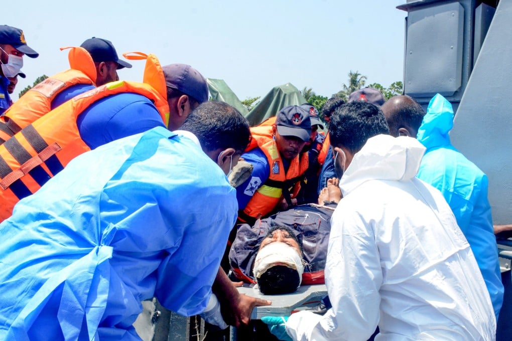 Medical personnel and Sri Lanka Navy sailors provide emergency treatment to an injured Iranian rescued from the IRIS Dena on March 4. Photo: Sri Lanka Navy/Reuters