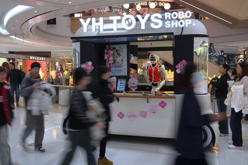 Shoppers walk past a humanoid robot selling toys in a shopping mall in Beijing on February 28. China’s common prosperity agenda, despite its imperfections, reflects an explicit recognition that unchecked inequality is a systemic risk. Photo: AP