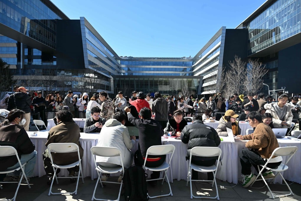 Engineers (front) install OpenClaw on people’s laptops at Baidu’s headquarters in Beijing on Wednesday. Photo: AFP