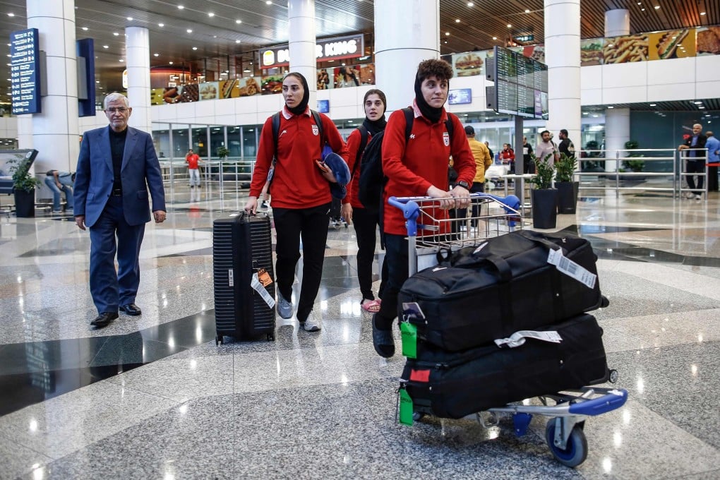 Members of Iran’s women’s football team walk with their luggage as they arrive at Kuala Lumpur International Airport on Wednesday. Photo: AFP