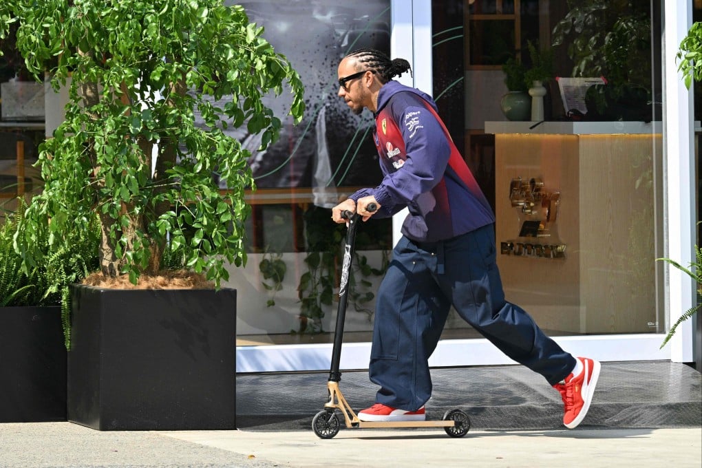 Ferrari’s British driver Lewis Hamilton rides a scooter in the paddock on Thursday at the Shanghai International Circuit ahead of the F1 Chinese Grand Prix this weekend. Photo: AFP