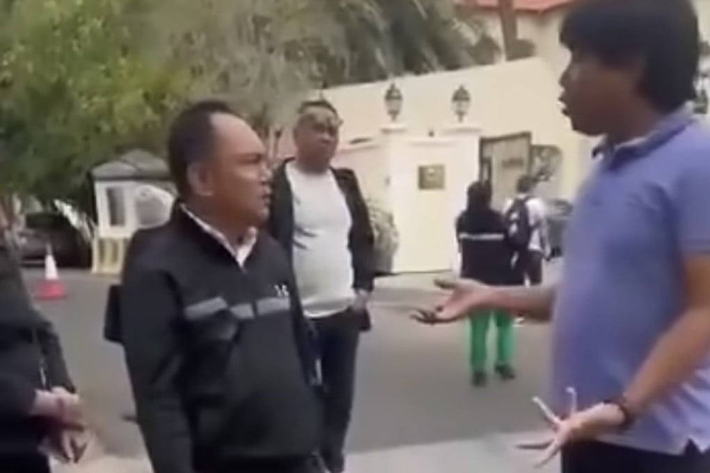 A Philippine official from the Migrant Workers Office (right) telling Filipino workers stranded in Bahrain that they are unable to receive financial support outside Manila’s embassy in the kingdom. Photo: Facebook/DDS News