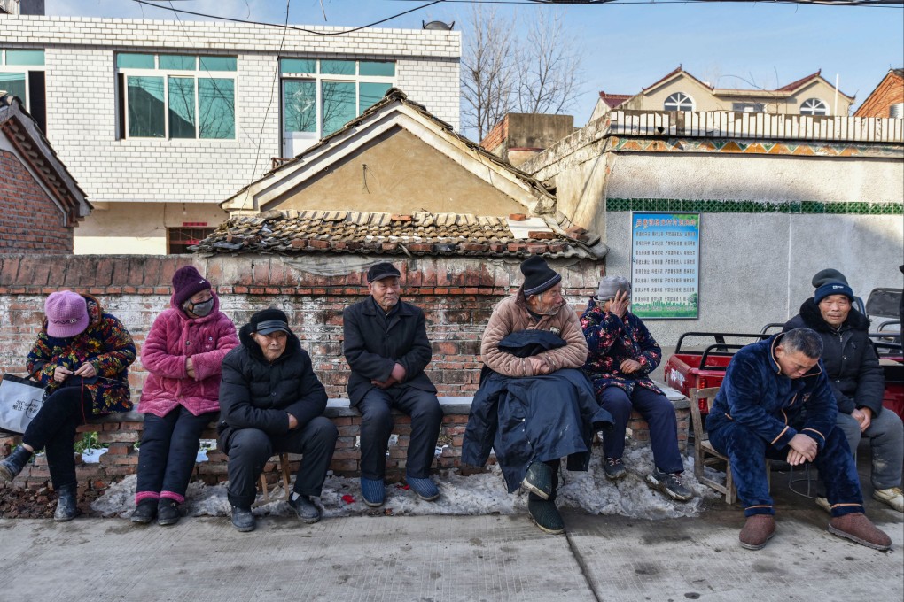 Elderly rural residents sit on a roadside in China’s Anhui province. Photo: Getty Images