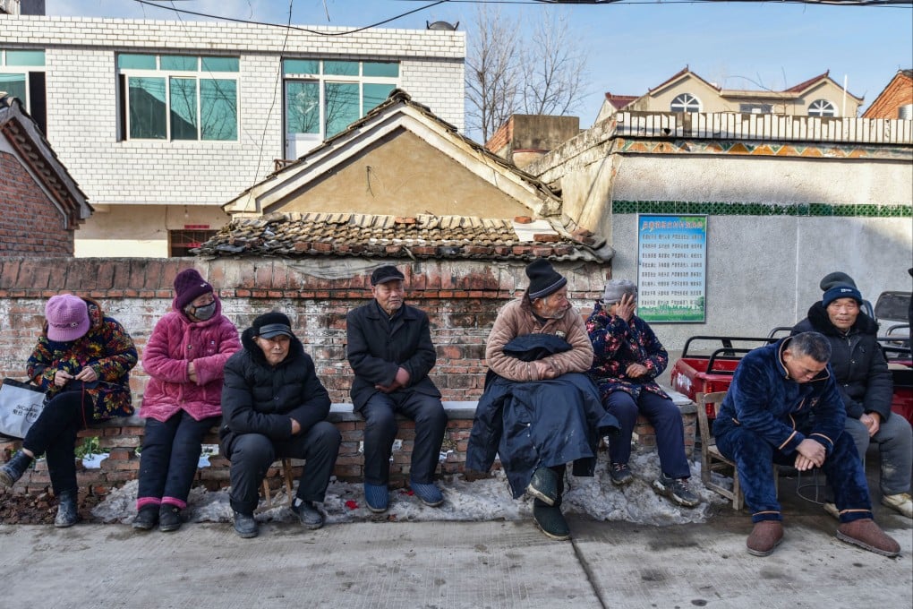 Elderly rural residents sit on a roadside in China’s Anhui province. Photo: Getty Images