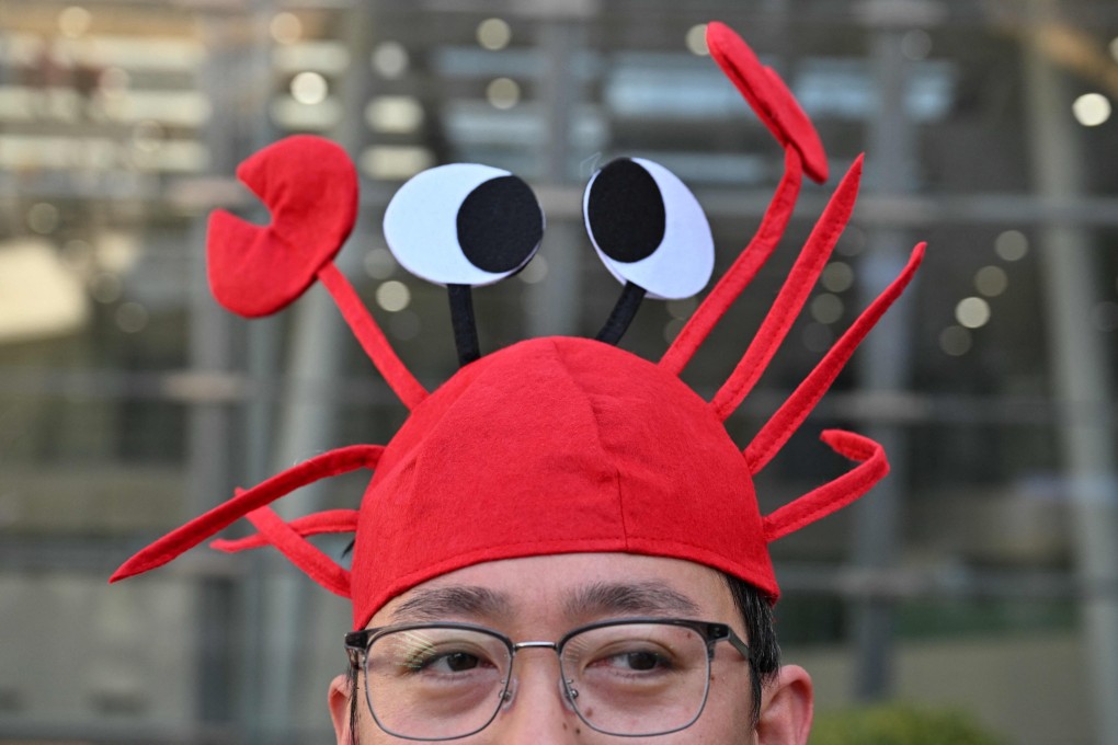 A man wears a lobster hat representing the OpenClaw logo at Baidu’s headquarters in Beijing. Photo: AFP