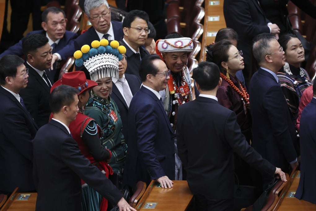 Delegates chat after the second plenary meeting of the Fourth Session of the 14th National People’s Congress in Beijing on March 9. Photo: EPA