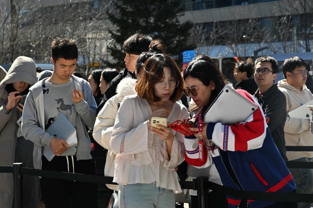Members of the public queue to have their laptops installed with OpenClaw, an open-source AI assistant, in Beijing on March 11. Photo: AFP