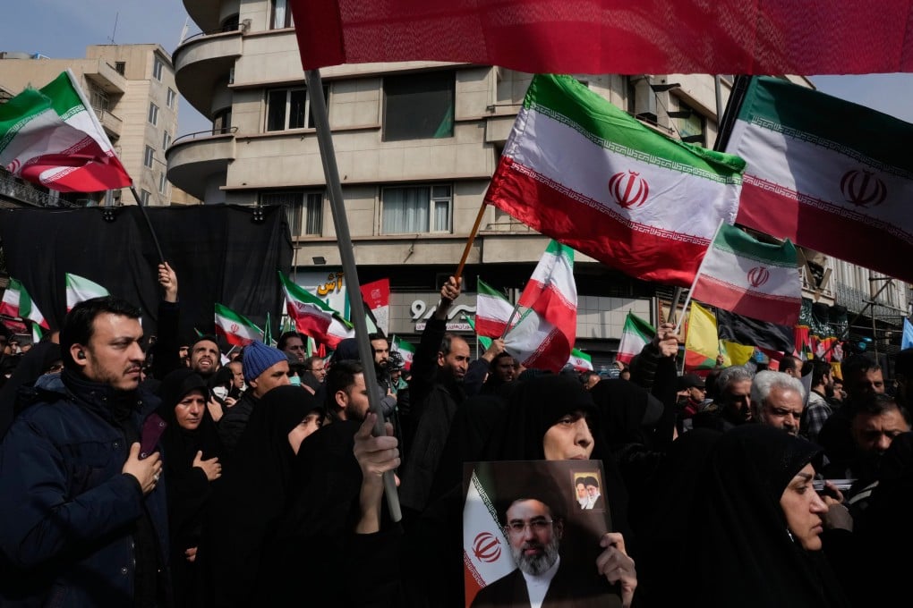 Mourners wave Iranian flags during the funeral procession for senior military officials and civilians killed during the US-Israel campaign in Tehran on Wednesday. Photo: AP
