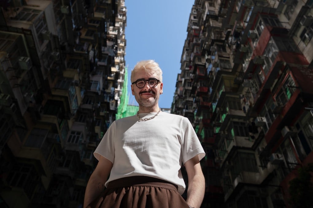 James Taylor-Foster poses for a photo in front of the “Monster Building” in Quarry Bay. He is the newly appointed executive director of Para Site art space in Hong Kong. Photo: Elson Li
