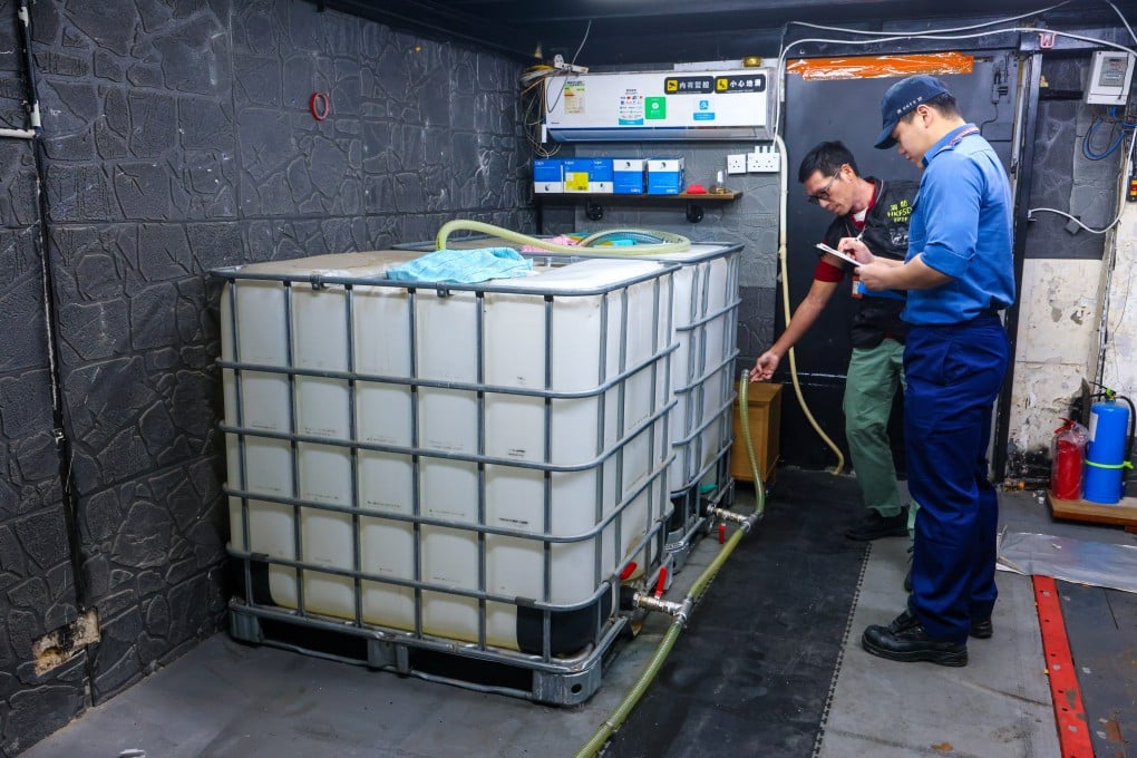 Hong Kong Fire Services Department officers crack down on an illicit petrol station at Yick Fung Building in To Kwa Wan, where three 1,000-litre containers were used for unauthorised storage and refuelling operations. Photo: Dickson Lee