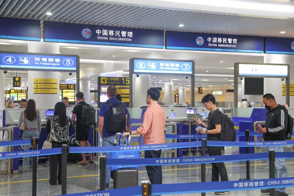 Inbound passengers line up at a border check inside Chongqing Jiangbei International Airport in southwest China’s Chongqing. Photo: Xinhua