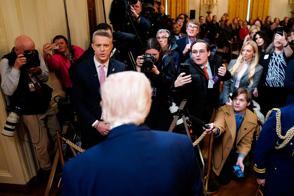 Members of the media question US President Donald Trump following a Women’s History Month event at the White House in Washington on March 12. Photo: Reuters