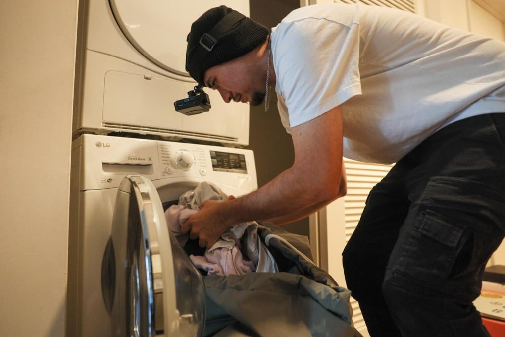 Los Angeles resident Salvador Arciga films himself doing the laundry for a data collection job in Los Angeles, California. Photo: TNS