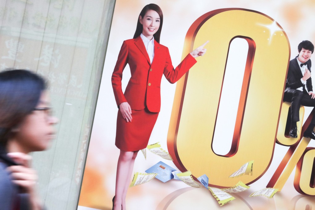 A pedestrian walks past a moneylending advertisement in Hong Kong. Photo: Felix Wong
