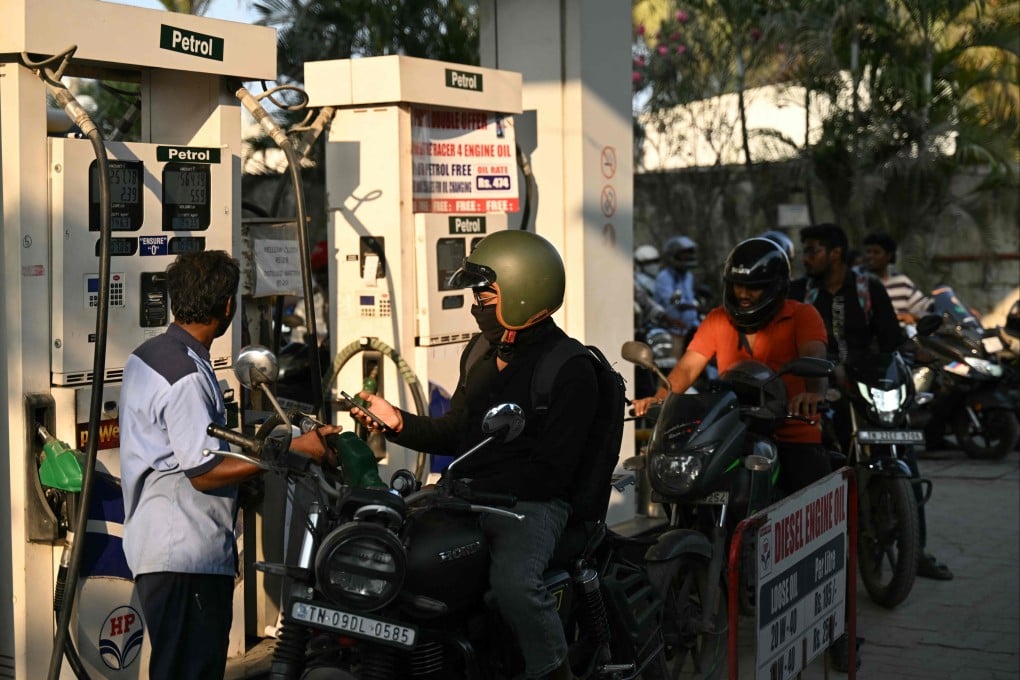People queue up to refuel their vehicles at a petrol station in Chennai, India on Thursday. Photo: AFP