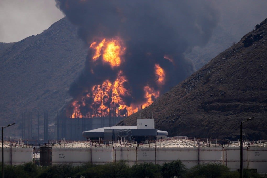 A fire and plume of smoke rise on Saturday after, authorities say, debris from an intercepted Iranian drone struck an oil facility in Fujairah in the United Arab Emirates. Photo: AP