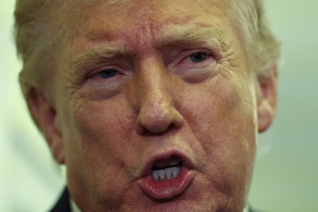 US President Donald Trump speaks to reporters aboard Air Force One on a flight back to Washington on Sunday. Photo: Reuters