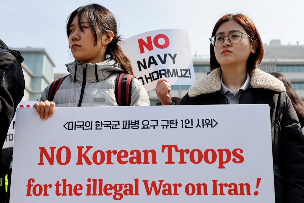 Activists hold placards during a rally against the US demand for South Korea to deploy troops to the Strait of Hormuz, outside the US embassy in Seoul on Monday. Photo: Reuters