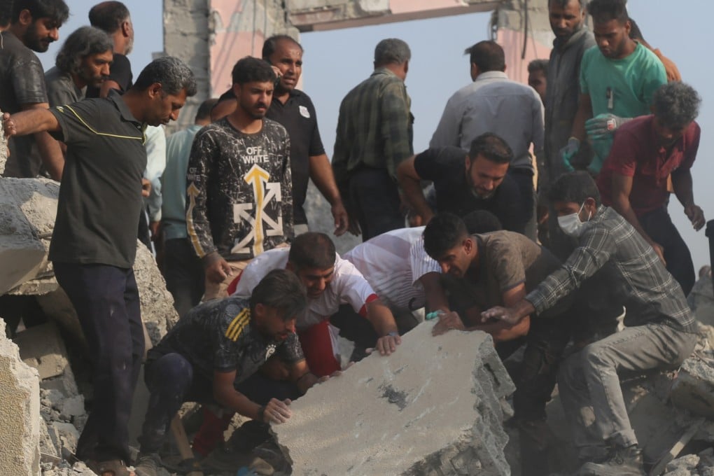Rescuers search through the rubble after a girls’ school in Minab, Iran, is hit by a missile on February 28. Photo: AP