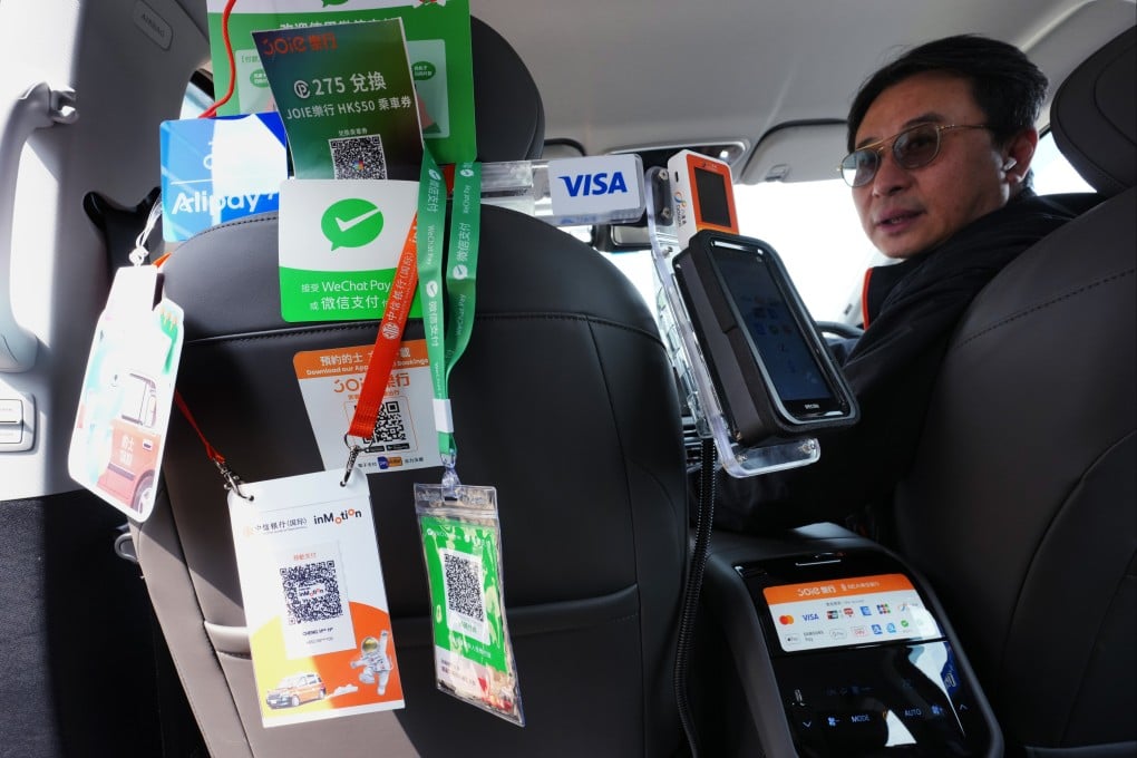 A taxi interior is plastered with advertising for various electronic payment systems for settling fares, on March 10. Taxis are required to offer at least two e-payment options – one QR code-based and one non-QR code method – from April 1. Photo: Jelly Tse