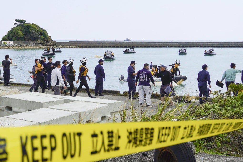 Japan Coast Guard officials prepare to to search at a port in Henoko after two boats capsize on Monday. Photo: Kyodo