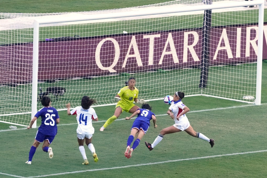 Japan’s Riko Ueki (number 9) heads past Philippines’ goalkeeper Nina Meollo in their 7-0 quarter-final win in Sydney on Sunday. Photo: AP