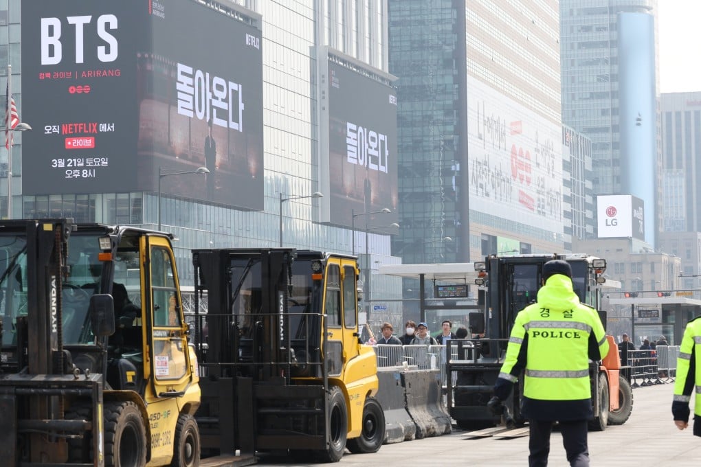 Workers set up the stage for a free concert by K-pop group BTS at Gwanghwamun Square in Seoul on Monday. Photo: EPA