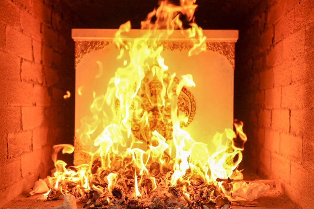 A coffin burns during a Thai cremation ceremony. Many crematoria in Thailand use diesel in their furnaces. Photo: Shutterstock