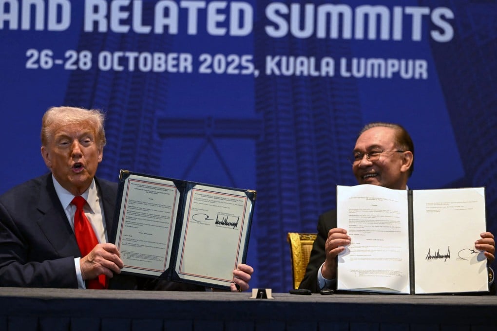 US President Donald Trump and Malaysia’s Prime Minister Anwar Ibrahim hold up signed documents on a trade deal in Kuala Lumpur on October 26, 2025. Photo: AFP