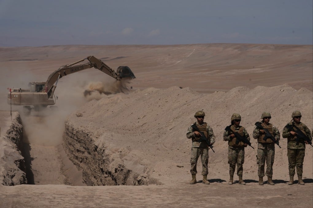 A machine digs along a section of Chile’s northern border. Photo: AP