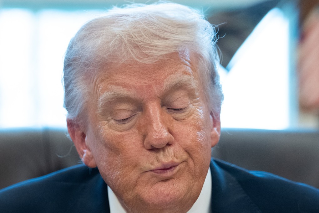 US President Donald Trump signs an executive order at the White House on Monday. Photo: EPA