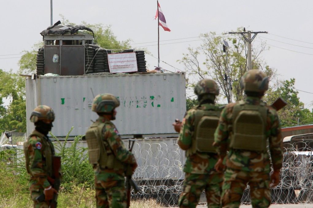 Cambodian soldiers stand guard in front of containers and barbed wires put up by Thailand in Banteay Meanchey province, Cambodia, on Friday. Photo:  EPA