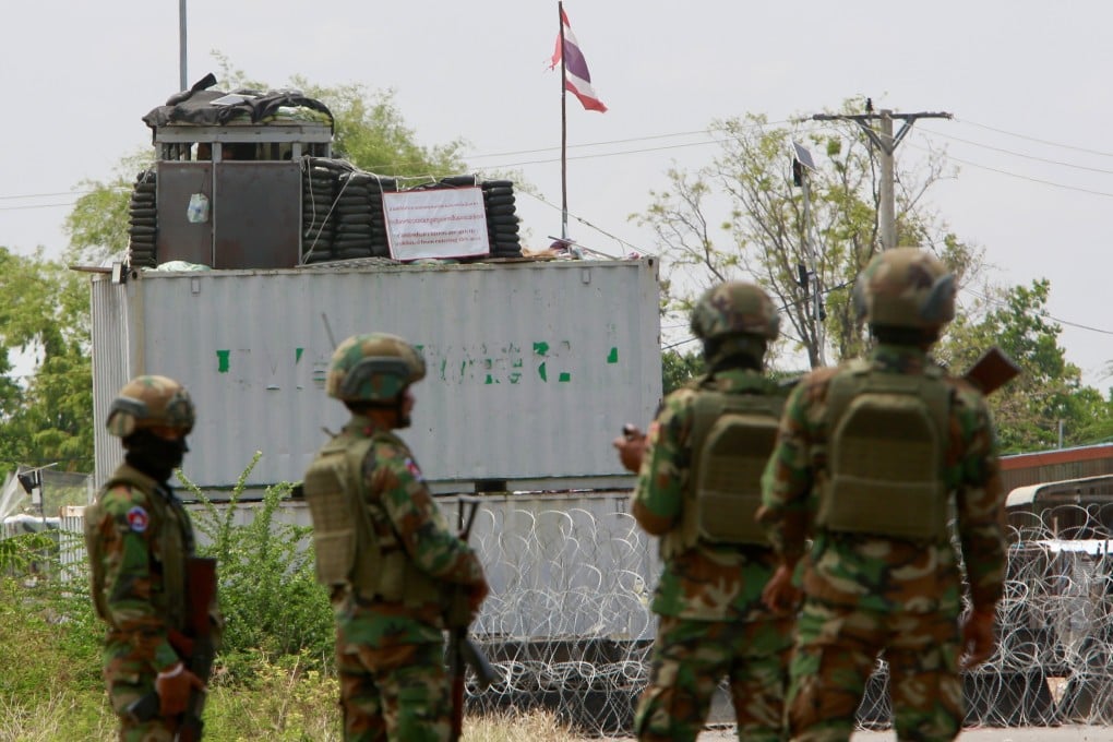 Cambodian soldiers stand guard in front of containers and barbed wires put up by Thailand in Banteay Meanchey province, Cambodia, on Friday. Photo: EPA