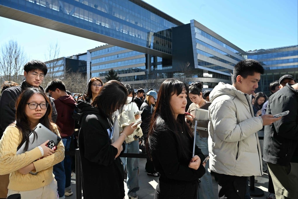 People queue to have their laptops installed with OpenClaw, an open-source AI assistant, at the Baidu headquarters in Beijing on March 11. Photo: AFP