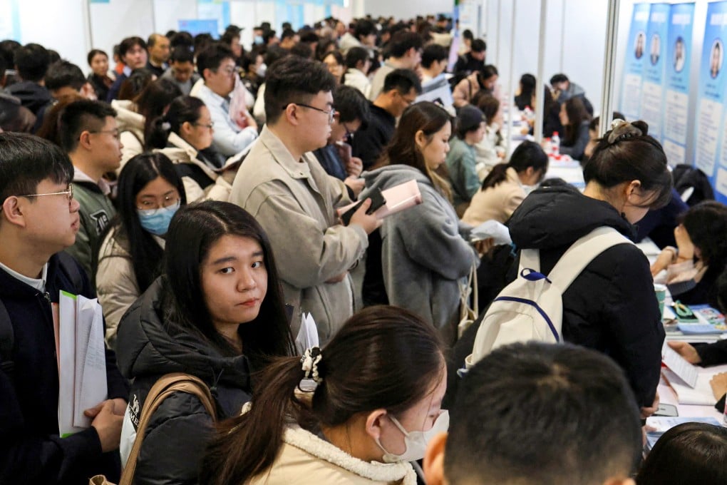 Young people line up at career guidance booths during a job fair in Beijing on March 14 as China’s youth unemployment rate grows amid a testing post-holiday labour market. Photo: Reuters