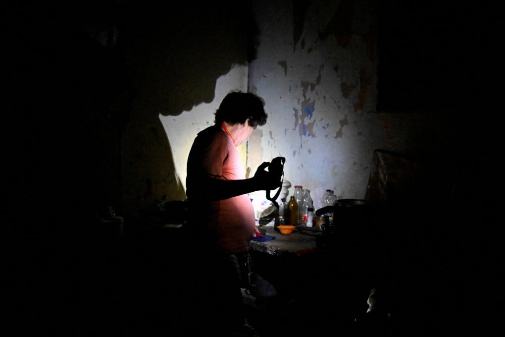 A man uses a flashlight after Cuba’s national electric grid collapsed. Photo: Reuters