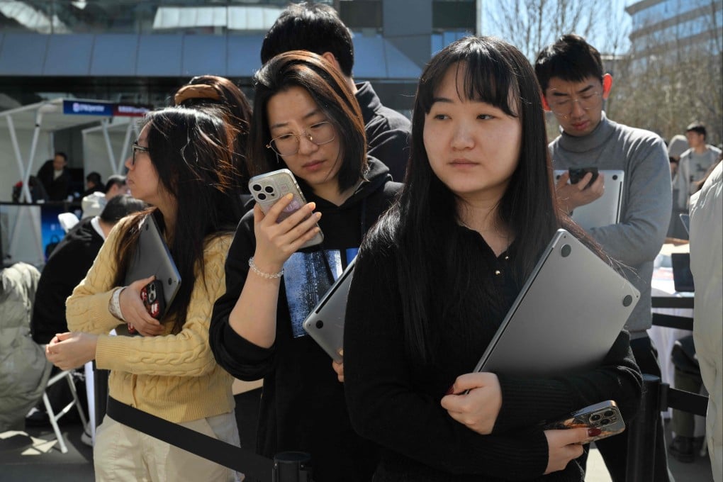 People queue to have the OpenClaw AI agent installed on their laptops at Baidu’s headquarters in Beijing on March 11. Photo: AFP