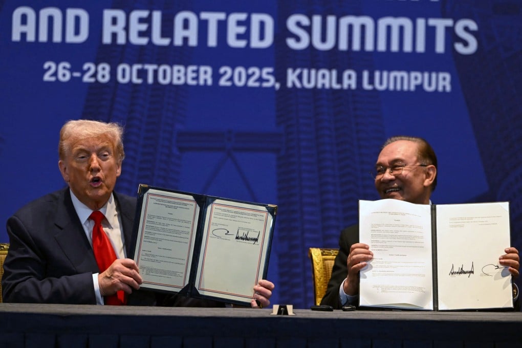 US President Donald Trump (left) and Malaysia’s Prime Minister Anwar Ibrahim hold up signed documents on a trade deal in Kuala Lumpur on October 26, 2025. Photo: AFP