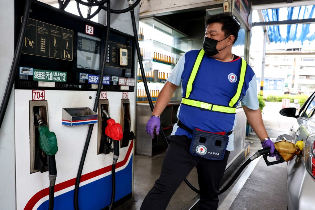 A petrol station worker refuels a car in Taipei on March 9. Photo: AFP