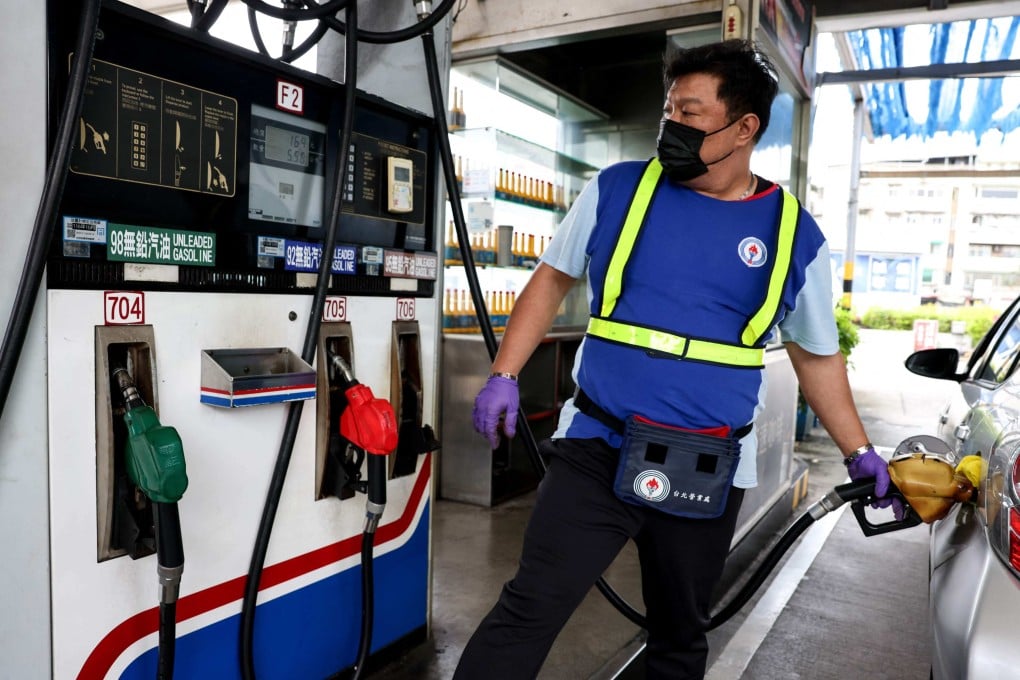 A petrol station worker refuels a car in Taipei on March 9. Photo: AFP