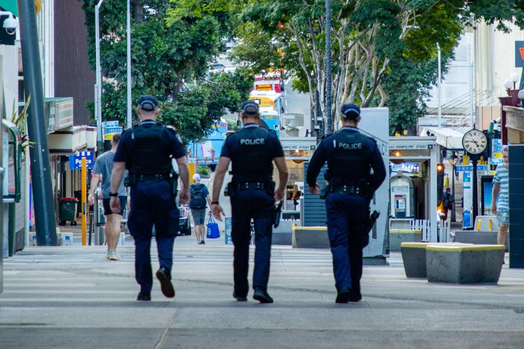 Police officers patrol the Valley Mall in Brisbane. Photo: AFP