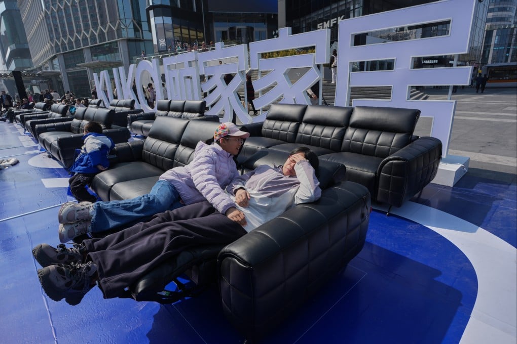 Shoppers test sofas outside a mall in Beijing. Retailers in Beijing and other major Chinese cities are increasingly moving product displays into public areas to boost spending. Photo: AP